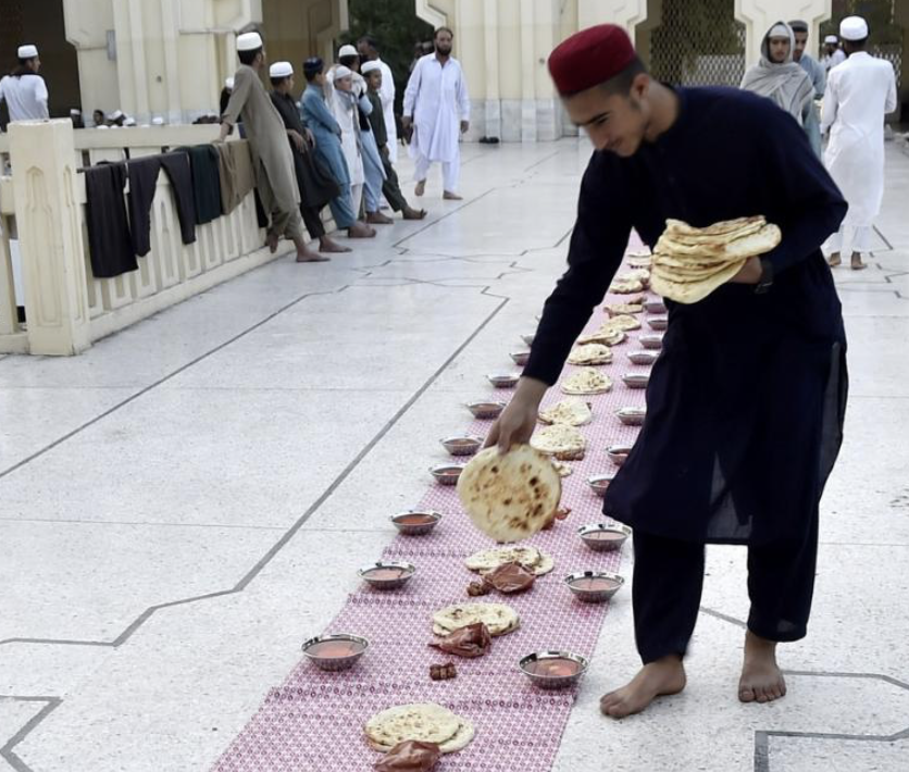 People gather to break the fast at a local mosque.